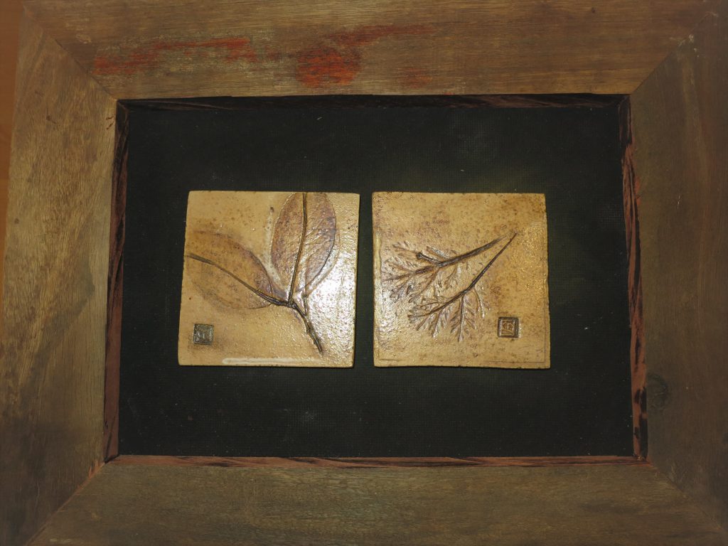 Ceramic designer tiles in wooden frame